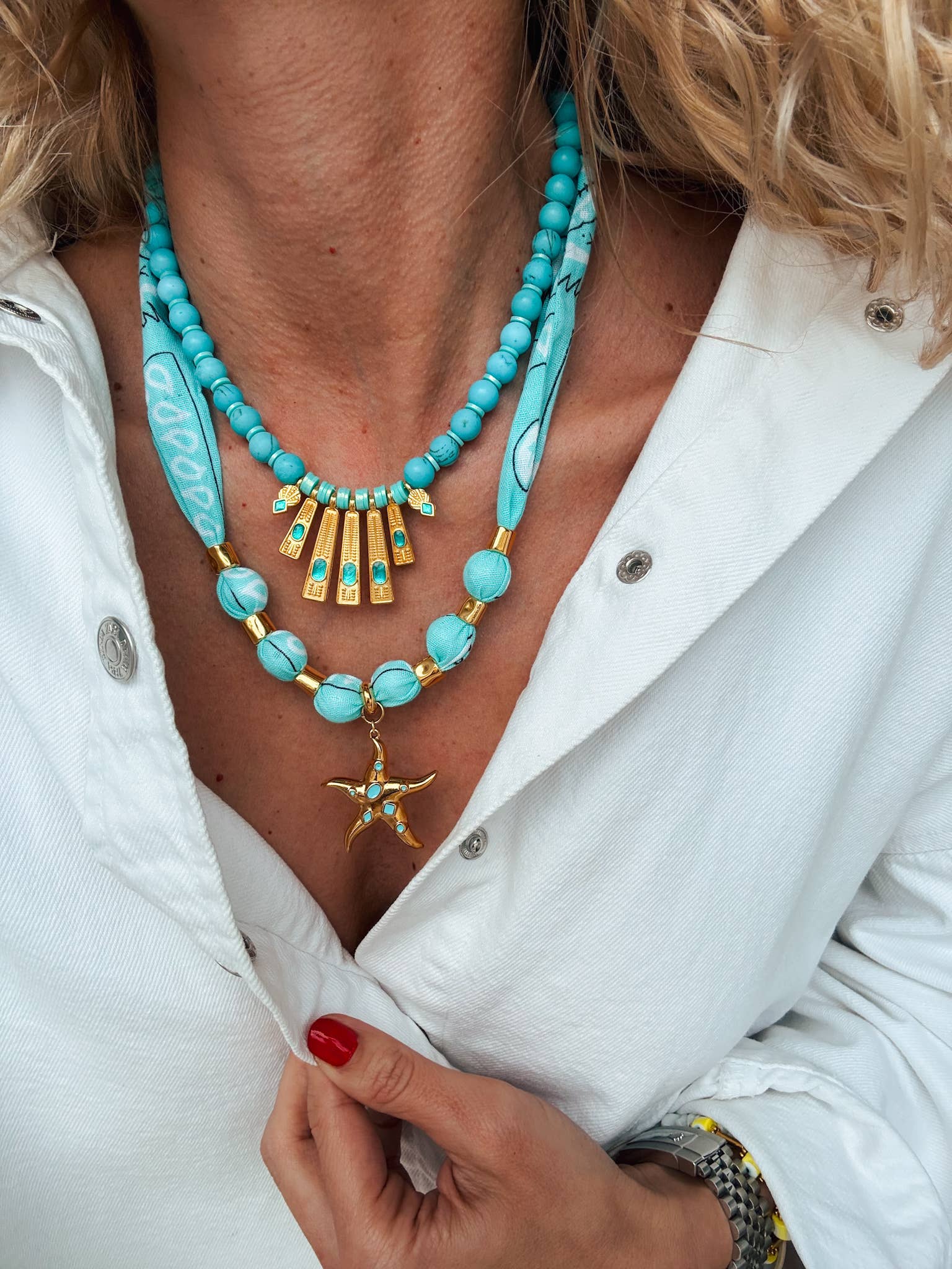 Turquoise-blue beaded necklace with a gold fan pendant and starfish charm