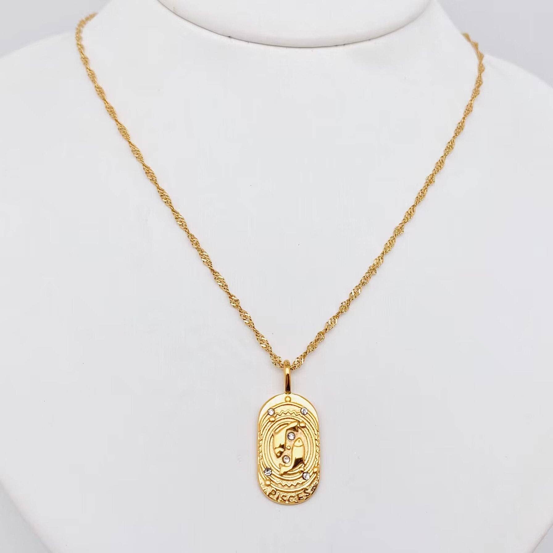 Gold Pisces constellation necklace with engraved celestial design