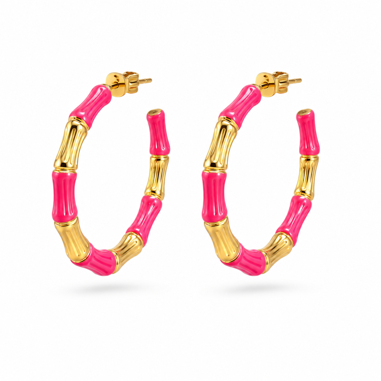 Pink and gold hoop earrings on a white background