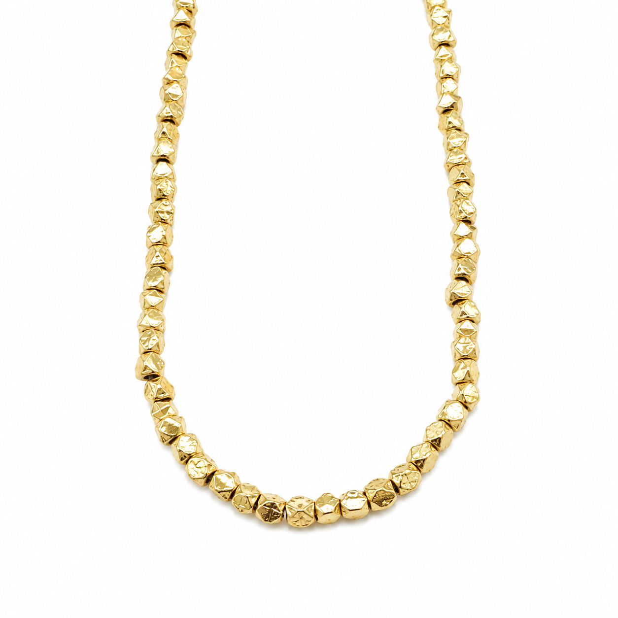 Double-strand necklace of faceted gold-toned beads with a small tassel.
