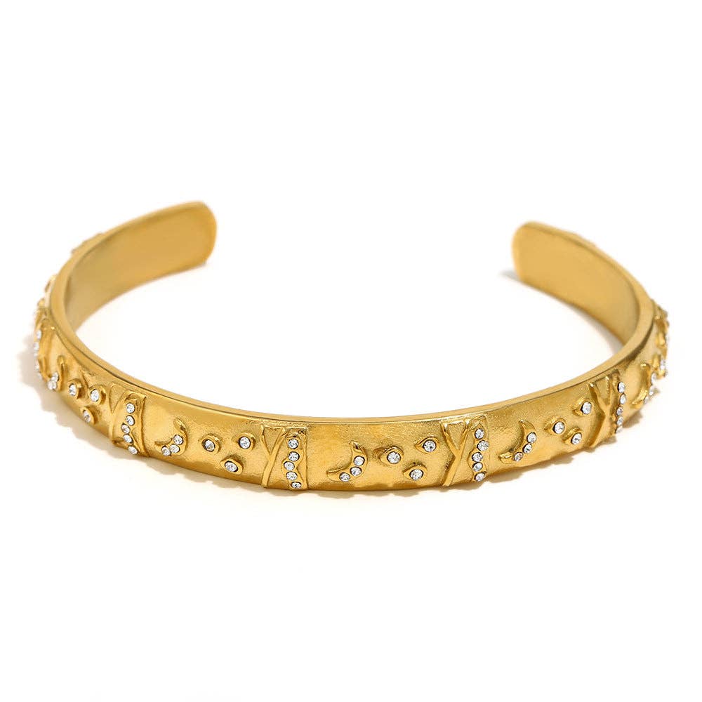 Gold-plated tarot-inspired cuff bangle with symbolic Holy Grail detailing and sculptural artisan design.