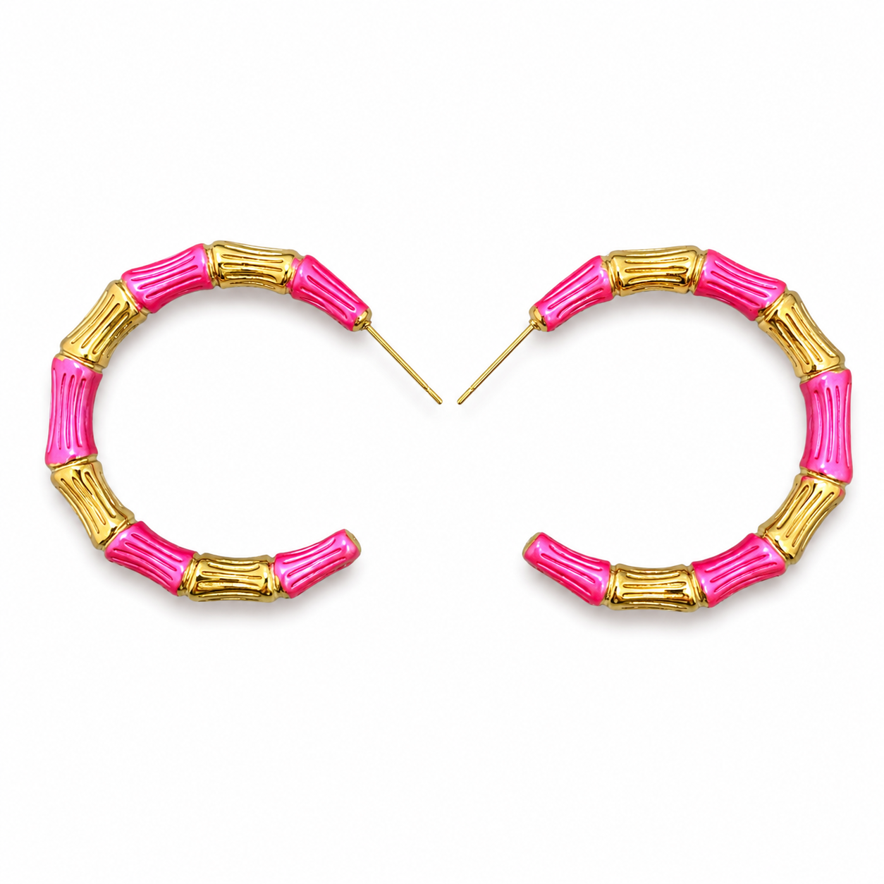 Pink and gold hoop earrings on a white background