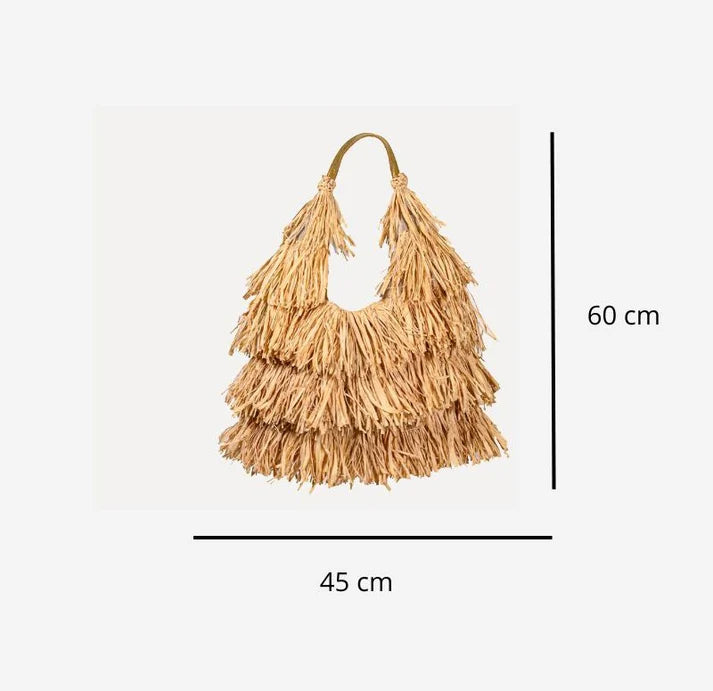 Raffia fringe shoulder bag shown front-on with its bronze leather handle.
