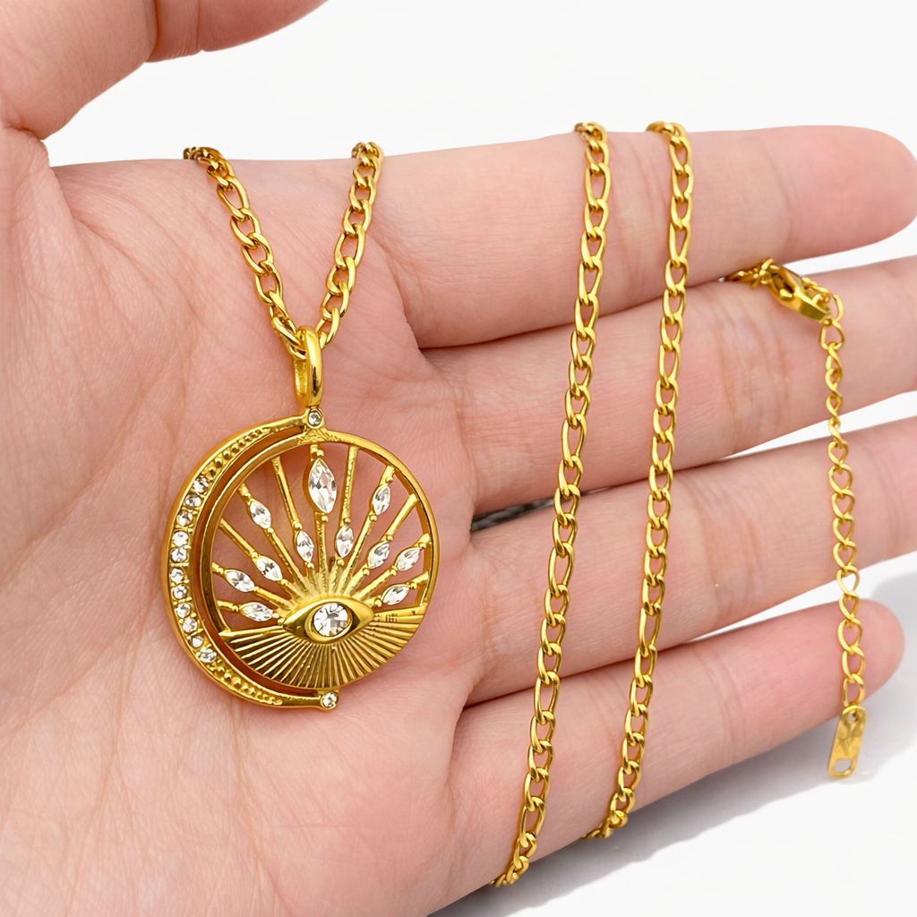 Gold celestial medallion necklace worn in hand