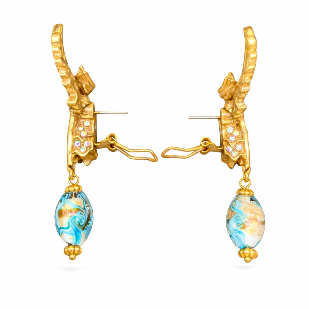 Vintage angel wing statement earrings with rhinestones, delicate glaze detailing, and ear clip design in warm gold tones.